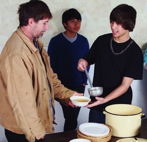 Teenagers Serving A Meal To A Man